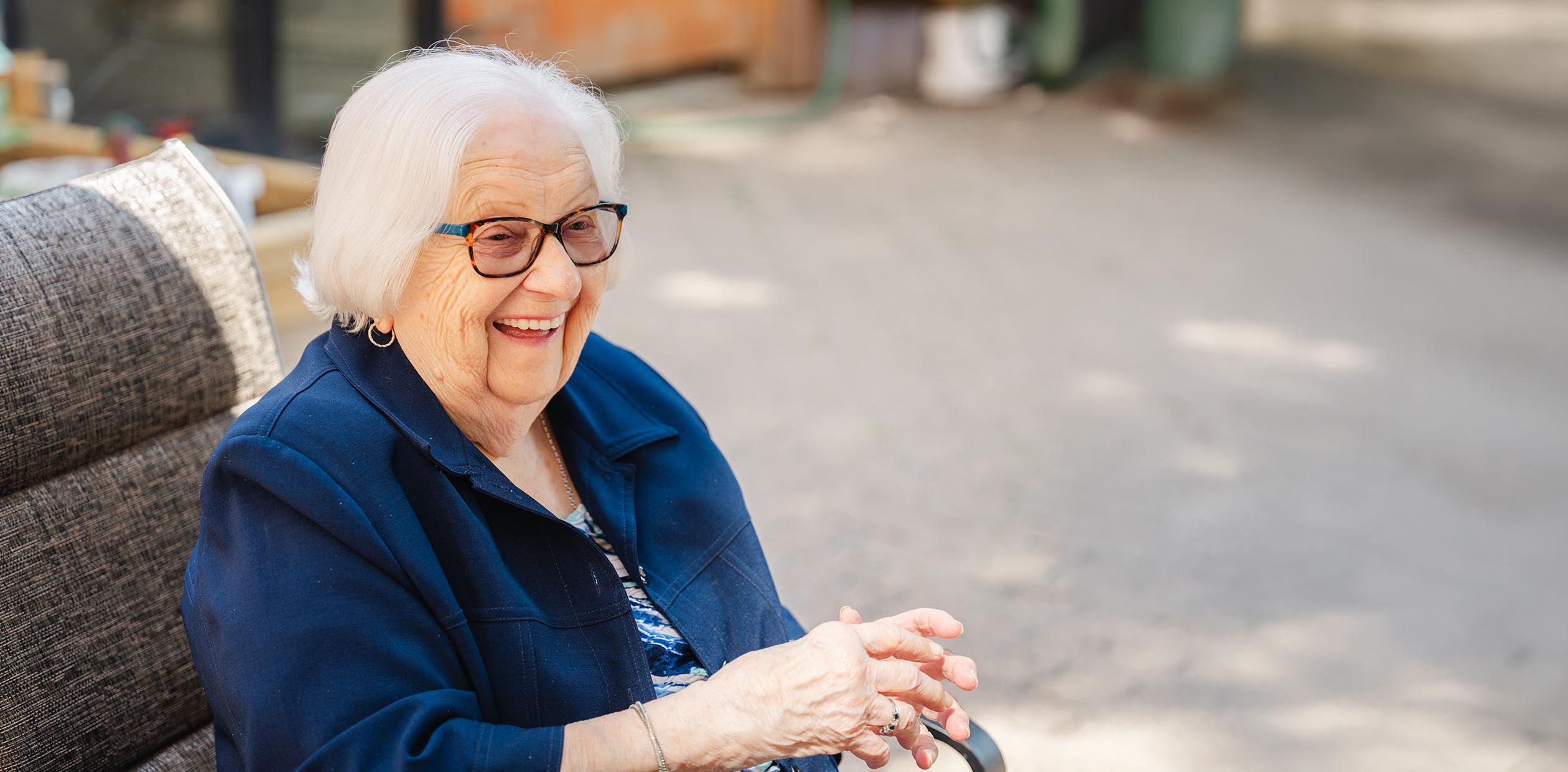 Senior woman sitting outside at Edmonton retirement home